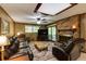 Comfortable living room featuring a brick fireplace, wood paneling, and natural light at 2425 Maclaren Cir, Dunwoody, GA 30360