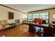 Bright home office with a large window, hardwood floors, and comfortable seating area at 2425 Maclaren Cir, Dunwoody, GA 30360