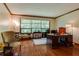 Spacious home office featuring a large window, hardwood floors, and elegant furnishings at 2425 Maclaren Cir, Dunwoody, GA 30360