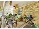 Back patio with seating, grilling area, brick facade, and an outdoor ceiling fan at 2425 Maclaren Cir, Dunwoody, GA 30360
