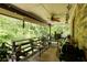 Back patio with seating, greenery, wood railing, brick facade, and a ceiling fan at 2425 Maclaren Cir, Dunwoody, GA 30360