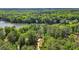 Scenic aerial image of a wooded lot featuring a private driveway, lake view, and mature trees at 5159 Sw East Shore Sw Dr, Conyers, GA 30094
