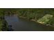 Waterfront lot next to a calm lake with a wooded shoreline and mature trees at 5159 Sw East Shore Sw Dr, Conyers, GA 30094