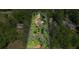 Aerial view of a wooded property surrounded by trees, highlighted with property lines for easy visualization at 5159 Sw East Shore Sw Dr, Conyers, GA 30094