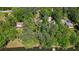 Overhead perspective showcasing a wooded property with lake access, mature trees, and a tranquil setting at 5159 Sw East Shore Sw Dr, Conyers, GA 30094