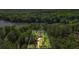 Aerial view of a wooded lot bordered in white, providing a view of mature trees, lake, and driveway at 5159 Sw East Shore Sw Dr, Conyers, GA 30094