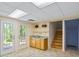 Basement area with utility sink, storage shelves, and walkout access to the exterior at 5159 Sw East Shore Sw Dr, Conyers, GA 30094