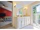Bathroom with double vanity, good lighting, and a glimpse into the bedroom at 5159 Sw East Shore Sw Dr, Conyers, GA 30094