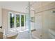 Bathroom featuring a glass-enclosed shower and a large window with natural light at 5159 Sw East Shore Sw Dr, Conyers, GA 30094