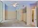 Bedroom with an ensuite bathroom has large windows, neutral walls, and a ceiling fan at 5159 Sw East Shore Sw Dr, Conyers, GA 30094