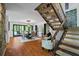 Dining room and staircase featuring a long dining table, and hardwood floors at 5159 Sw East Shore Sw Dr, Conyers, GA 30094
