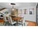 Dining room featuring wood table with seating for six, modern light fixture and decorative stone wall at 5159 Sw East Shore Sw Dr, Conyers, GA 30094