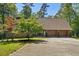 Charming single story home with a 2-car garage, surrounded by lush greenery and mature trees at 5159 Sw East Shore Sw Dr, Conyers, GA 30094