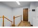 Upstairs hallway with laundry closet, wood railing, and view of a washing machine at 5159 Sw East Shore Sw Dr, Conyers, GA 30094