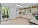 Vintage kitchen featuring large window, tile floor, tile countertop and all white appliances at 5159 Sw East Shore Sw Dr, Conyers, GA 30094