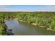 Scenic lake view with lush trees lining the shore, creating a peaceful natural landscape at 5159 Sw East Shore Sw Dr, Conyers, GA 30094