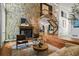 Open-concept living area with stone fireplace, wood floors, and staircase to the second floor at 5159 Sw East Shore Sw Dr, Conyers, GA 30094