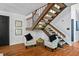 Cozy seating area featuring a staircase, hardwood floors, and neutral decor at 5159 Sw East Shore Sw Dr, Conyers, GA 30094