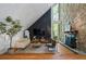 Bright living room with a stone fireplace, chic furniture, and a modern entertainment area at 5159 Sw East Shore Sw Dr, Conyers, GA 30094
