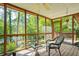 The cozy screened porch offers a relaxing space with wicker furniture and views of the green backyard at 5159 Sw East Shore Sw Dr, Conyers, GA 30094