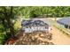 Backyard featuring white home exterior with green landscaping and a mature tree at 783 Britt Sw Rd, Mableton, GA 30126