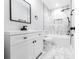 Modern bathroom with marble-look tile, black hardware, a tub, and a white vanity at 783 Britt Sw Rd, Mableton, GA 30126