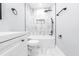 Stylish bathroom with white marble-look tile, black accents, and a shower/tub combo at 783 Britt Sw Rd, Mableton, GA 30126