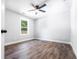 Bedroom features luxury vinyl plank floors, neutral paint, and a window overlooking the backyard at 783 Britt Sw Rd, Mableton, GA 30126