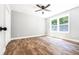 Bedroom featuring modern lighting, luxury vinyl plank floors, and a bright window at 783 Britt Sw Rd, Mableton, GA 30126