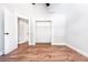 Bright bedroom with wood floors, fresh paint, open closet, and white trim at 783 Britt Sw Rd, Mableton, GA 30126