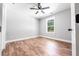 Bright bedroom with luxury vinyl plank flooring, ceiling fan, and a window with backyard views at 783 Britt Sw Rd, Mableton, GA 30126