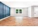 The living room features a navy blue wall and newly installed wood floors at 783 Britt Sw Rd, Mableton, GA 30126