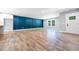 Spacious living room features luxury vinyl plank flooring, modern windows, and board and batten accent wall at 783 Britt Sw Rd, Mableton, GA 30126