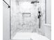 Modern shower with white marble-look tile, black hardware, and recessed niche at 783 Britt Sw Rd, Mableton, GA 30126