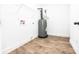 Utility room featuring wood-look flooring, water heater, and white trim at 783 Britt Sw Rd, Mableton, GA 30126