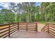 Backyard deck overlooking green trees and gravel area at 1213 Anderson Mill Rd, Austell, GA 30106