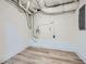 Unfinished basement area showing exposed pipes, cinderblock wall and concrete flooring at 1213 Anderson Mill Rd, Austell, GA 30106