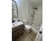 Modern bathroom featuring textured tile shower, wood vanity and stone tile flooring at 1213 Anderson Mill Rd, Austell, GA 30106