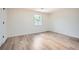 A bright bedroom features a window and wood-look flooring at 1213 Anderson Mill Rd, Austell, GA 30106