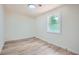 A bright bedroom features a window and wood-look flooring at 1213 Anderson Mill Rd, Austell, GA 30106