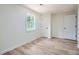 A bright bedroom features a window and wood-look flooring at 1213 Anderson Mill Rd, Austell, GA 30106