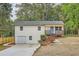 Charming two-story home features a welcoming blue door and a well-maintained front yard with garden at 1213 Anderson Mill Rd, Austell, GA 30106