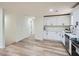 Bright kitchen features stainless steel appliances, white cabinets, and wood-look flooring at 1213 Anderson Mill Rd, Austell, GA 30106