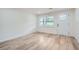 Bright, airy room featuring wood-look floors, a window, and a white door at 1213 Anderson Mill Rd, Austell, GA 30106