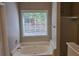 Relaxing bathroom featuring a large soaking tub with a window view and a glass-enclosed shower at 1511 Harbor Watch Ct, Woodstock, GA 30189