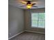 Neutral bedroom with ceiling fan and window providing natural light at 1511 Harbor Watch Ct, Woodstock, GA 30189