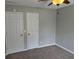 Bedroom featuring two doors with neutral carpet, paint, and trim at 1511 Harbor Watch Ct, Woodstock, GA 30189