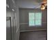 Neutral bedroom with a ceiling fan and a window view to a wooded area at 1511 Harbor Watch Ct, Woodstock, GA 30189