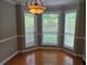 Sunlit dining nook featuring a bay window, hardwood floors, and an elegant light fixture at 1511 Harbor Watch Ct, Woodstock, GA 30189