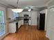 Well-lit kitchen with stainless steel appliances, white cabinetry, and hardwood floors at 1511 Harbor Watch Ct, Woodstock, GA 30189